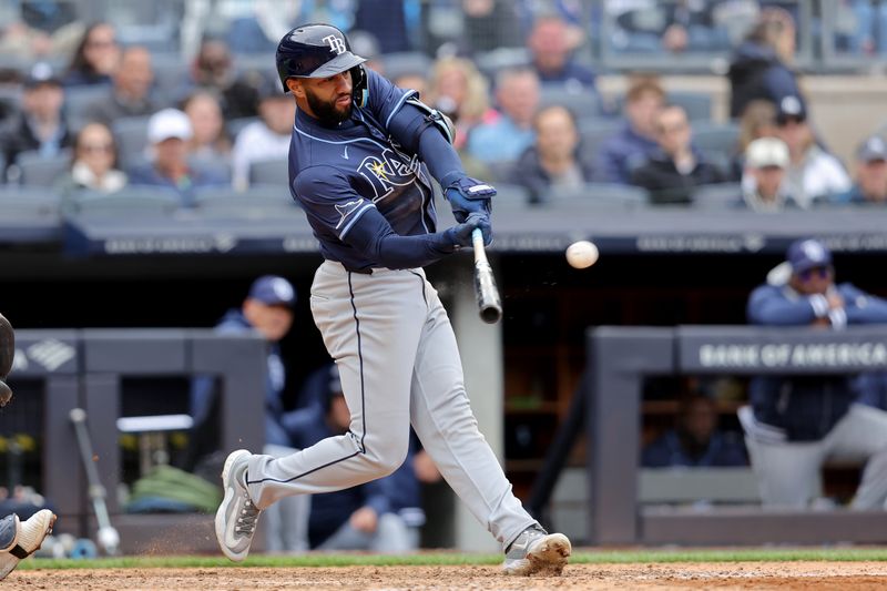 Apr 21, 2024; Bronx, New York, USA; Tampa Bay Rays right fielder Amed Rosario (10) hits a two run double against the New York Yankees during the eighth inning at Yankee Stadium. Mandatory Credit: Brad Penner-USA TODAY Sports