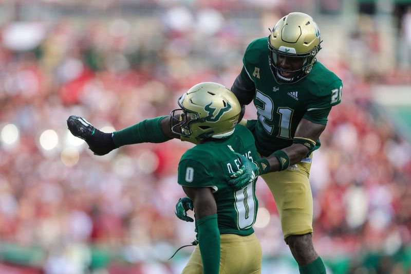 Sep 16, 2023; Tampa, Florida, USA;  South Florida Bulls defensive back Jaelen Stokes (21) and South Florida Bulls defensive back Daquan Evans (0) celebrate after a play against the Alabama Crimson Tide in the second quarter at Raymond James Stadium. Mandatory Credit: Nathan Ray Seebeck-USA TODAY Sports