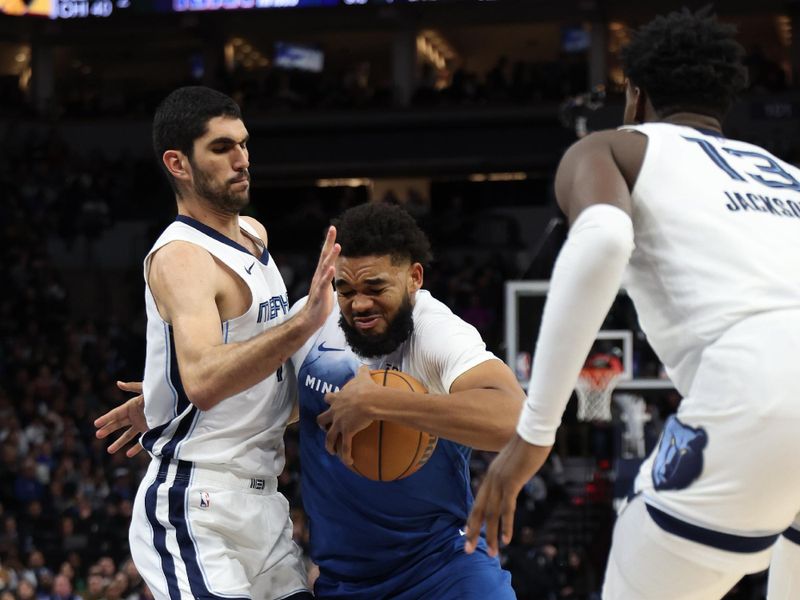 MINNEAPOLIS, MN -  FEBRUARY 28:  Karl-Anthony Towns #32 of the Minnesota Timberwolves drives to the basket during the game as Santi Aldama #7 of the Memphis Grizzlies plays defense on February 28, 2024 at Target Center in Minneapolis, Minnesota. NOTE TO USER: User expressly acknowledges and agrees that, by downloading and or using this Photograph, user is consenting to the terms and conditions of the Getty Images License Agreement. Mandatory Copyright Notice: Copyright 2024 NBAE (Photo by Jordan Johnson/NBAE via Getty Images)