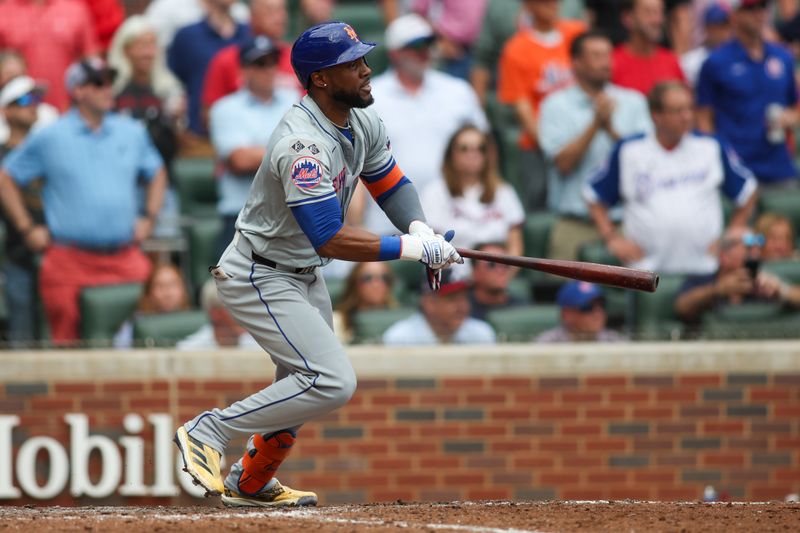 Sep 30, 2024; Atlanta, Georgia, USA; New York Mets right fielder Starling Marte (6) hits a single against the Atlanta Braves in the ninth inning at Truist Park. Mandatory Credit: Brett Davis-Imagn Images