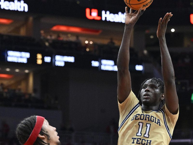 Feb 10, 2024; Louisville, Kentucky, USA; Georgia Tech Yellow Jackets forward Baye Ndongo (11) shoots against Louisville Cardinals guard Tre White (22) during the first half at KFC Yum! Center. Mandatory Credit: Jamie Rhodes-USA TODAY Sports