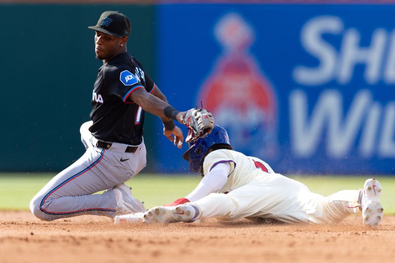 Jun 29, 2024; Philadelphia, Pennsylvania, USA; Philadelphia Phillies outfielder Johan Rojas (18) steals second base past Miami Marlins shortstop Tim Anderson (7) during the fifth inning at Citizens Bank Park. Mandatory Credit: Bill Streicher-USA TODAY Sports