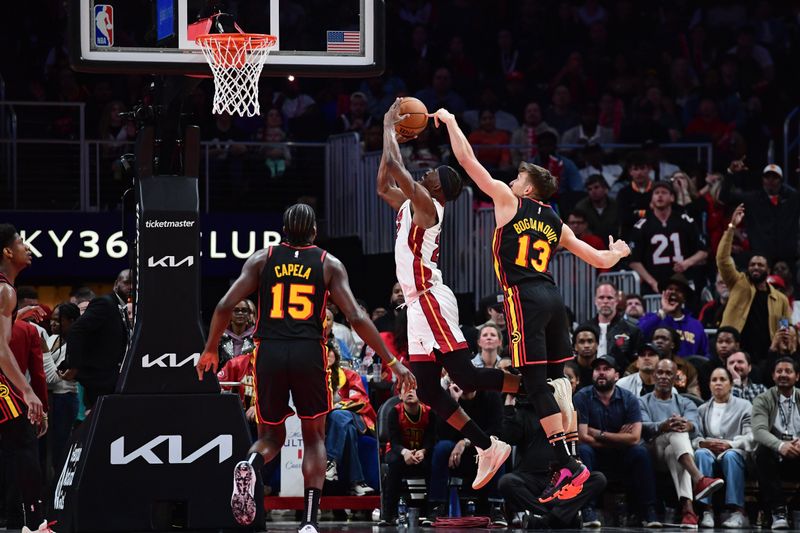 ATLANTA, GA - APRIL 9: Bogdan Bogdanovic #13 of the Atlanta Hawks blocks a shot during the game against the Miami Heat on April 9, 2024 at State Farm Arena in Atlanta, Georgia.  NOTE TO USER: User expressly acknowledges and agrees that, by downloading and/or using this Photograph, user is consenting to the terms and conditions of the Getty Images License Agreement. Mandatory Copyright Notice: Copyright 2024 NBAE (Photo by Scott Cunningham/NBAE via Getty Images)