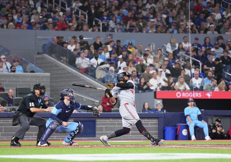 May 11, 2024; Toronto, Ontario, CAN; Minnesota Twins first base Carlos Santana (30) hits a three run home run against the Toronto Blue Jays during the third inning at Rogers Centre. Mandatory Credit: Nick Turchiaro-USA TODAY Sports