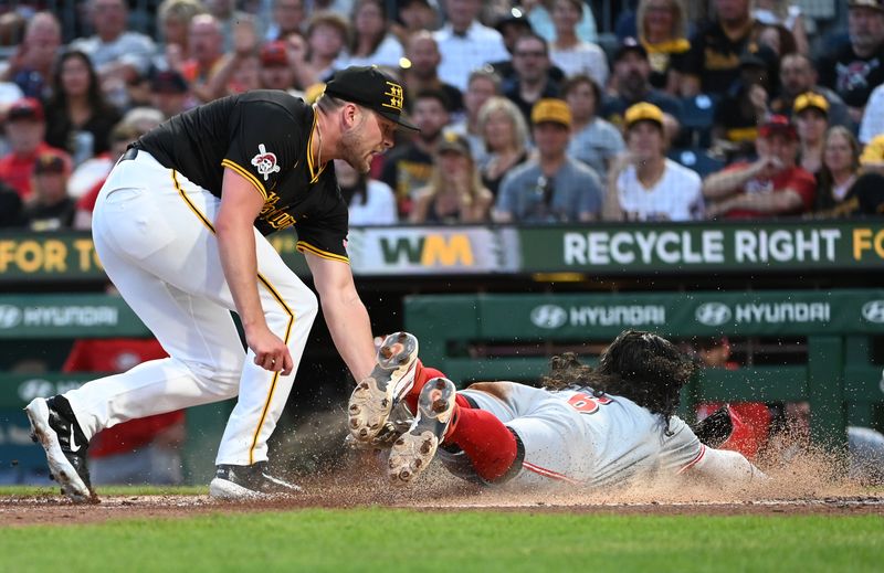 Aug 24, 2024; Pittsburgh, Pennsylvania, USA;  Cincinnati Reds second baseman Jonathan India (6) slides safety into home as Pittsburgh Pirates pitcher Hunter Stratton (63) tries to apply the tag during the fourth inning at PNC Park. Stratton left the game with an apparent injury on the play. Mandatory Credit: Philip G. Pavely-USA TODAY Sports