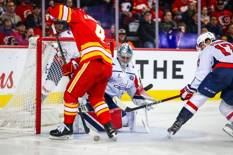 Jan 28, 2025; Calgary, Alberta, CAN; Washington Capitals goaltender Logan Thompson (48) makes a save against Calgary Flames defenseman Rasmus Andersson (4) during the second period at Scotiabank Saddledome. Mandatory Credit: Sergei Belski-Imagn Images