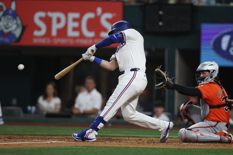 Jul 20, 2024; Arlington, Texas, USA; Texas Rangers catcher Andrew Knizner (12) doubles in two runs against the Baltimore Orioles in the second inning at Globe Life Field. Mandatory Credit: Tim Heitman-USA TODAY Sports