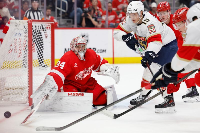 Mar 2, 2024; Detroit, Michigan, USA; Detroit Red Wings goaltender Alex Lyon (34) makes a save in front of Florida Panthers center Anton Lundell (15) in the third period at Little Caesars Arena. Mandatory Credit: Rick Osentoski-USA TODAY Sports