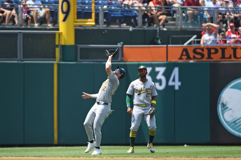 Jul 14, 2024; Philadelphia, Pennsylvania, USA; Oakland Athletics shortstop Max Schuemann (12) makes a catch during the second inning against the Philadelphia Phillies at Citizens Bank Park. Mandatory Credit: Eric Hartline-USA TODAY Sports