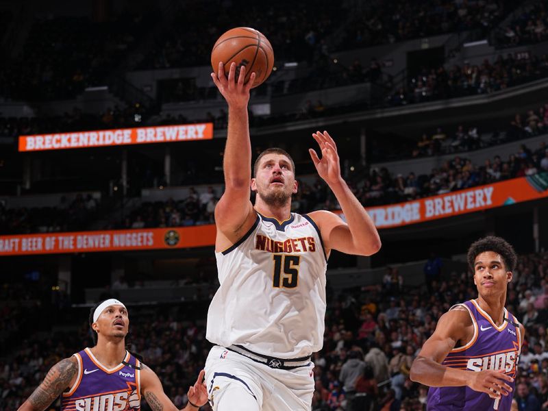 DENVER, CO - OCTOBER 13: Nikola Jokic #15 of the Denver Nuggets drives to the basket during the game against the Phoenix Suns on October 13, 2024 at Ball Arena in Denver, Colorado. NOTE TO USER: User expressly acknowledges and agrees that, by downloading and/or using this Photograph, user is consenting to the terms and conditions of the Getty Images License Agreement. Mandatory Copyright Notice: Copyright 2024 NBAE (Photo by Bart Young/NBAE via Getty Images)