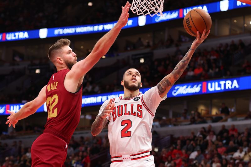 CHICAGO, ILLINOIS - OCTOBER 18: Lonzo Ball #2 of the Chicago Bulls goes up for a layup against Dean Wade #32 of the Cleveland Cavaliers during the second half of a preseason game at the United Center on October 18, 2024 in Chicago, Illinois. NOTE TO USER: User expressly acknowledges and agrees that, by downloading and or using this photograph, User is consenting to the terms and conditions of the Getty Images License Agreement.  (Photo by Michael Reaves/Getty Images)