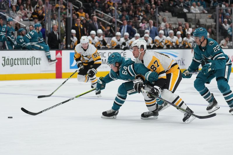 Nov 4, 2023; San Jose, California, USA; San Jose Sharks center Mikael Granlund (64) skates with the puck against Pittsburgh Penguins center Sidney Crosby (87) during the second period at SAP Center at San Jose. Mandatory Credit: Darren Yamashita-USA TODAY Sports