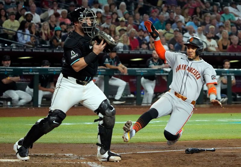 Jun 5, 2024; Phoenix, Arizona, USA; Arizona Diamondbacks catcher Tucker Barnhart (16) gets the force out on San Francisco Giants outfielder Heliot Ramos (17) in the sixth inning at Chase Field. Mandatory Credit: Rick Scuteri-USA TODAY Sports