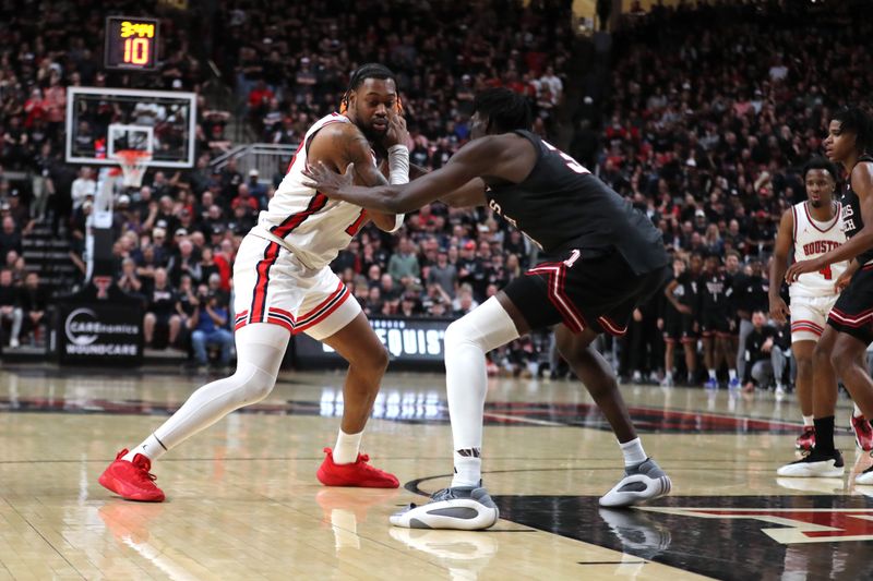 Feb 24, 2025; Lubbock, Texas, USA;  Houston Cougars forward J’Wan Roberts (13) looks for an opening against Texas Tech Red Raiders forward Federiko Federiko (33) in the second half at United Supermarkets Arena. Mandatory Credit: Michael C. Johnson-Imagn Images