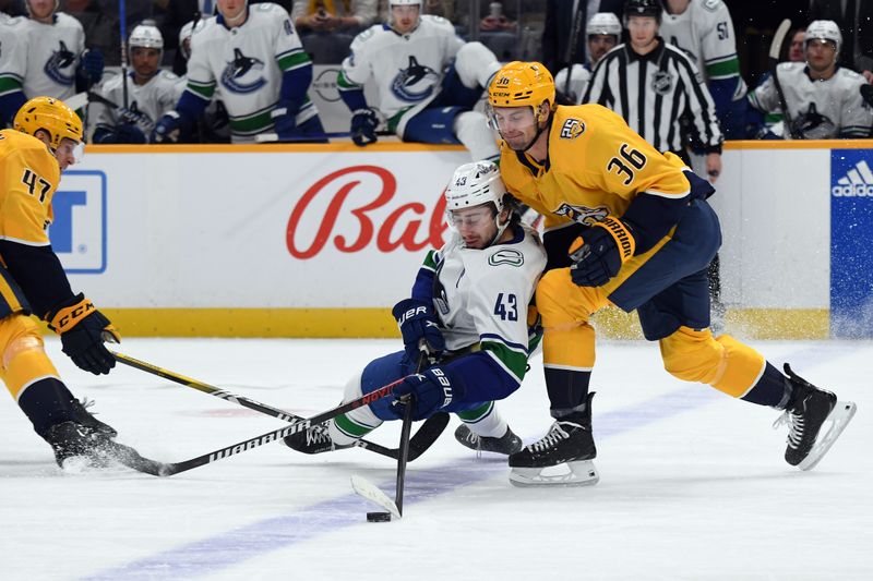 Dec 19, 2023; Nashville, Tennessee, USA; Vancouver Canucks defenseman Quinn Hughes (43) loses the puck as he is defended by Nashville Predators left wing Cole Smith (36) during the first period at Bridgestone Arena. Mandatory Credit: Christopher Hanewinckel-USA TODAY Sports