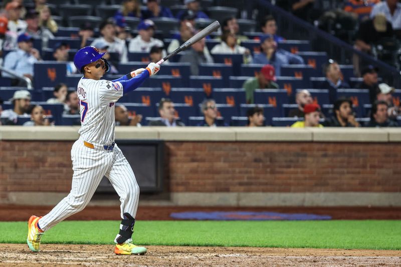 Sep 3, 2024; New York City, New York, USA;  New York Mets third baseman Mark Vientos (27) hits a solo home run in the seventh inning against the Boston Red Sox at Citi Field. Mandatory Credit: Wendell Cruz-Imagn Images