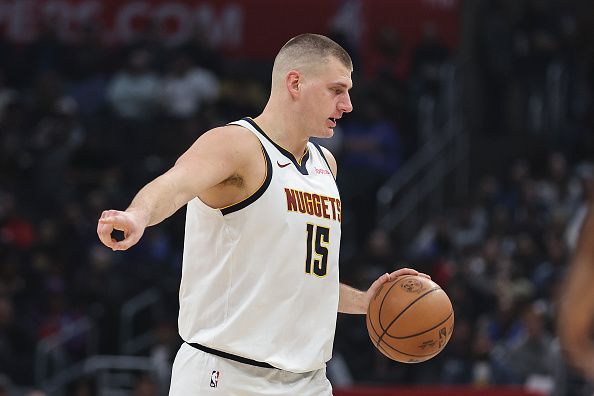 LOS ANGELES, CALIFORNIA - DECEMBER 06: Nikola Jokic #15 of the Denver Nuggets signals as he controls the ball against the LA Clippers during the first half of a game at Crypto.com Arena on December 06, 2023 in Los Angeles, California. NOTE TO USER: User expressly acknowledges and agrees that, by downloading and or using this photograph, User is consenting to the terms and conditions of the Getty Images License Agreement. (Photo by Michael Owens/Getty Images)