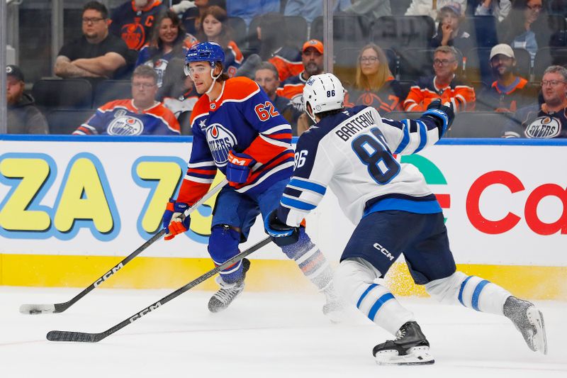 Sep 22, 2024; Edmonton, Alberta, CAN; Edmonton Oilers forward Raphael Lavoie (62) looks to make a pass in front of Winnipeg Jets defensemen Dawson Bartteaux (86) during the third period at Rogers Place. Mandatory Credit: Perry Nelson-Imagn Images