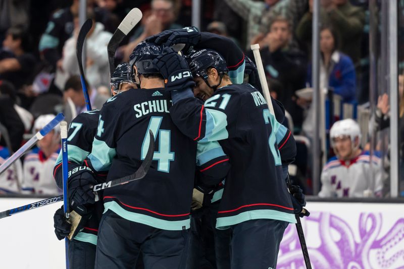 Nov 17, 2022; Seattle, Washington, USA; Seattle Kraken defenseman Justin Schultz (4) and forward Alex Wennberg (21) celebrate a goal with teammates during the third period at Climate Pledge Arena. Mandatory Credit: Stephen Brashear-USA TODAY Sports