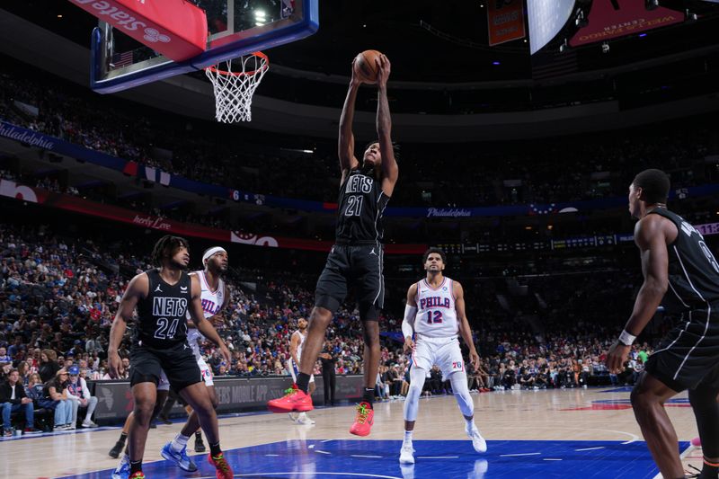 PHILADELPHIA, PA - APRIL 14: Noah Clowney #21 of the Brooklyn Nets  rebounds the ball during the game against the Philadelphia 76ers on April 14, 2024 at the Wells Fargo Center in Philadelphia, Pennsylvania NOTE TO USER: User expressly acknowledges and agrees that, by downloading and/or using this Photograph, user is consenting to the terms and conditions of the Getty Images License Agreement. Mandatory Copyright Notice: Copyright 2024 NBAE (Photo by Jesse D. Garrabrant/NBAE via Getty Images)