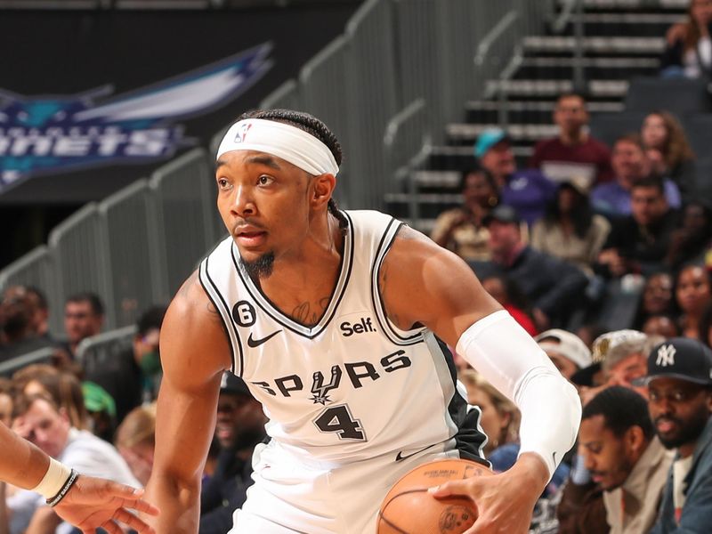 CHARLOTTE, NC - FEBUARY 15:  Devonte' Graham #4 of the San Antonio Spurs handles the ball during the game  on Febuary 15, 2023 at Spectrum Center in Charlotte, North Carolina. NOTE TO USER: User expressly acknowledges and agrees that, by downloading and or using this photograph, User is consenting to the terms and conditions of the Getty Images License Agreement. Mandatory Copyright Notice: Copyright 2023 NBAE (Photo by Kent Smith/NBAE via Getty Images)