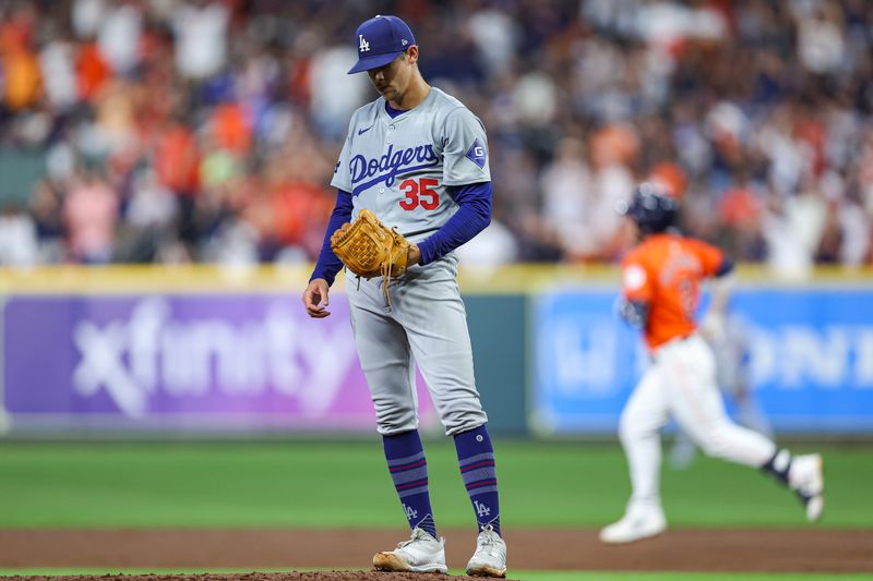 Jul 26, 2024; Houston, Texas, USA; Los Angeles Dodgers starting pitcher Gavin Stone (35) reacts and Houston Astros third baseman Alex Bregman (2) rounds the bases after hitting a home run during the third inning at Minute Maid Park. Mandatory Credit: Troy Taormina-USA TODAY Sports