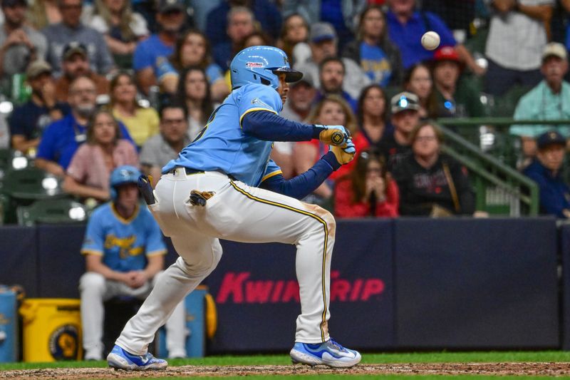 Jun 14, 2024; Milwaukee, Wisconsin, USA; Milwaukee Brewers center fielder Blake Perkins (16) popped bunt out in the ninth inning to end the game against the Milwaukee Brewers at American Family Field. Mandatory Credit: Benny Sieu-USA TODAY Sports