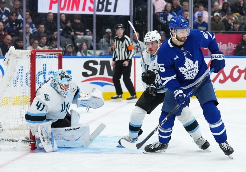 Nov 5, 2025; Toronto, Ontario, CAN; Toronto Maple Leafs center Nicolas Roy (55) battles with Utah Mammoth defenseman Nate Schmidt (88) during the third period at Scotiabank Arena. Mandatory Credit: Nick Turchiaro-Imagn Images