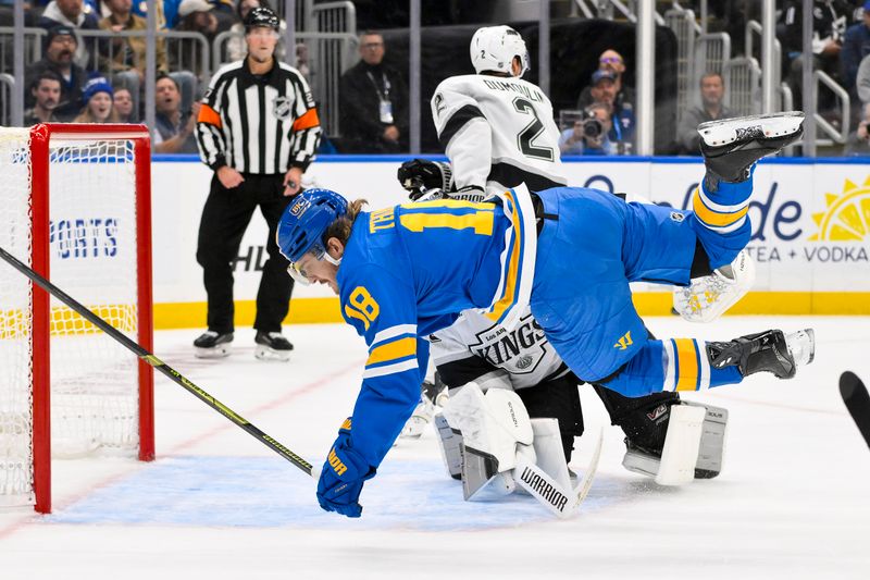 Oct 21, 2025; St. Louis, Missouri, USA; St. Louis Blues center Robert Thomas (18) falls to the ice as Los Angeles Kings goaltender Darcy Kuemper (35) defends during the second period at Enterprise Center. Mandatory Credit: Jeff Curry-Imagn Images
