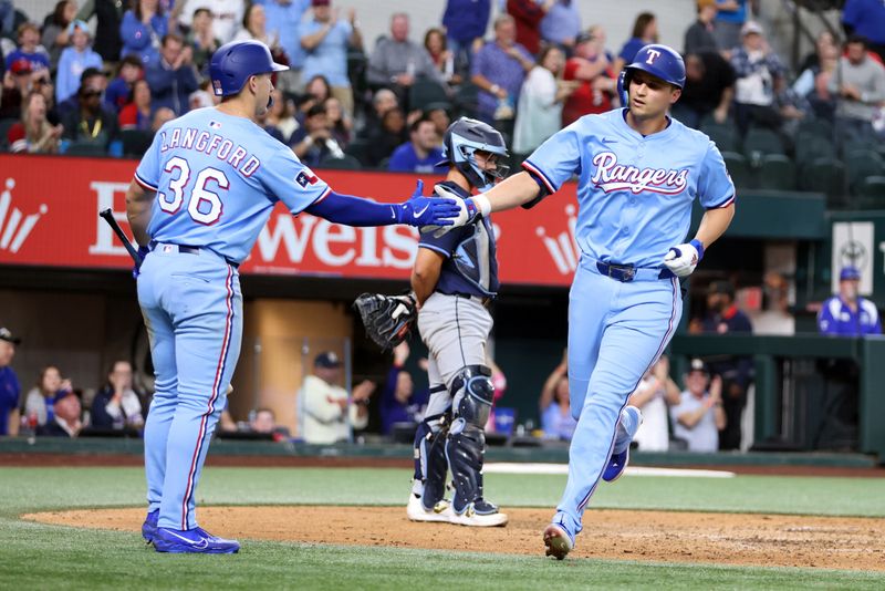 Apr 6, 2025; Arlington, Texas, USA; Texas Rangers shortstop Corey Seager (5) is congratulated by left fielder Wyatt Langford (36)after hitting a solo home run in the sixth inning against the Tampa Bay Rays at Globe Life Field. Mandatory Credit: Tim Heitman-Imagn Images