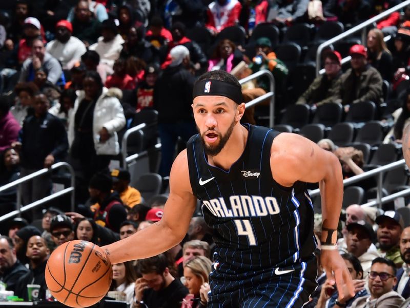 ATLANTA, GA - JANUARY 17: Jalen Suggs #4 of the Orlando Magic goes to the basket during the game on January 17, 2024 at State Farm Arena in Atlanta, Georgia.  NOTE TO USER: User expressly acknowledges and agrees that, by downloading and/or using this Photograph, user is consenting to the terms and conditions of the Getty Images License Agreement. Mandatory Copyright Notice: Copyright 2024 NBAE (Photo by Scott Cunningham/NBAE via Getty Images)