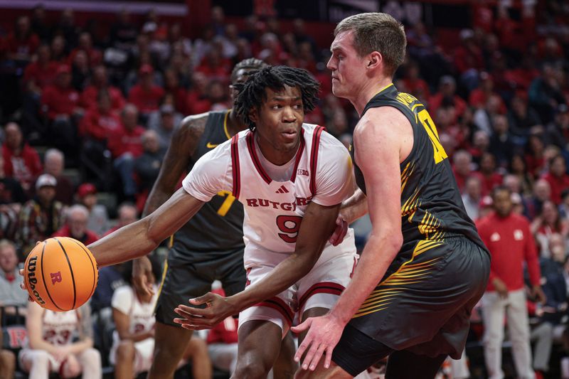 Feb 12, 2025; Piscataway, New Jersey, USA; Rutgers Scarlet Knights forward Dylan Grant (9) is guarded by Iowa Hawkeyes forward Payton Sandfort (20) during the first half at Jersey Mike's Arena. Mandatory Credit: Vincent Carchietta-Imagn Images