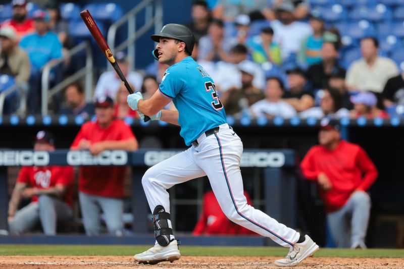 Apr 13, 2025; Miami, Florida, USA; Miami Marlins pinch hitter Matt Mervis (36) hits a three-run home run against the Washington Nationals during the seventh inning at loanDepot Park. Mandatory Credit: Sam Navarro-Imagn Images