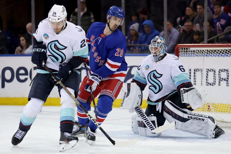 Jan 16, 2024; New York, New York, USA; New York Rangers left wing Chris Kreider (20) attempts to tip the puck against Seattle Kraken defenseman Jamie Oleksiak (24) and goaltender Chris Driedger (60) during the first period at Madison Square Garden. Mandatory Credit: Brad Penner-USA TODAY Sports