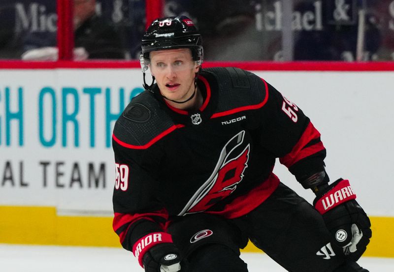 Mar 12, 2024; Raleigh, North Carolina, USA; Carolina Hurricanes left wing Jake Guentzel (59) skates against the New York Rangers during the first period at PNC Arena. Mandatory Credit: James Guillory-USA TODAY Sports