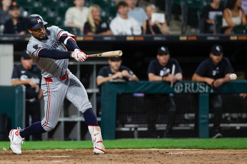 Jul 8, 2024; Chicago, Illinois, USA; Minnesota Twins outfielder Byron Buxton (25) hits a single against the Chicago White Sox during the 11th inning at Guaranteed Rate Field. Mandatory Credit: Kamil Krzaczynski-USA TODAY Sports