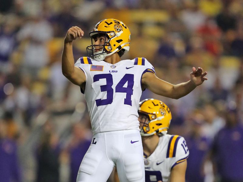 Oct 21, 2023; Baton Rouge, Louisiana, USA; LSU Tigers kicker Damian Ramos (34) hits an extra point against the Army Black Knights during the first half at Tiger Stadium. Mandatory Credit: Danny Wild-USA TODAY Sports