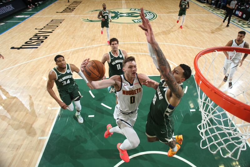 MILWAUKEE, WI - FEBRUARY 27: Christian Braun #0 of the Denver Nuggets drives to the basket during the game against the Milwaukee Bucks on February 27, 2025 at Fiserv Forum Center in Milwaukee, Wisconsin. NOTE TO USER: User expressly acknowledges and agrees that, by downloading and or using this Photograph, user is consenting to the terms and conditions of the Getty Images License Agreement. Mandatory Copyright Notice: Copyright 2025 NBAE (Photo by Gary Dineen/NBAE via Getty Images).