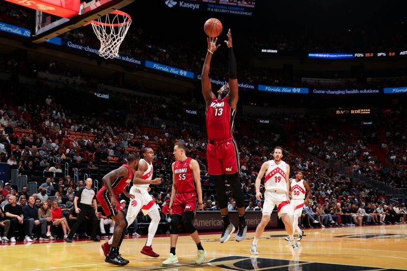 MIAMI, FL - NOVEMBER 29: Bam Adebayo #13 of the Miami Heat rebounds the ball during the game against the Toronto Raptors in the NBA Cup on November 29, 2024 at Kaseya Center in Miami, Florida. NOTE TO USER: User expressly acknowledges and agrees that, by downloading and or using this Photograph, user is consenting to the terms and conditions of the Getty Images License Agreement. Mandatory Copyright Notice: Copyright 2024 NBAE (Photo by Issac Baldizon/NBAE via Getty Images)
