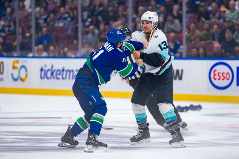 Sep 24, 2024; Vancouver, British Columbia, CAN; Vancouver Canucks defenseman Mark Friedman (51) fights with Seattle Kraken forward Brandon Tanev (13) during the third period at Rogers Arena. Mandatory Credit: Bob Frid-Imagn Images