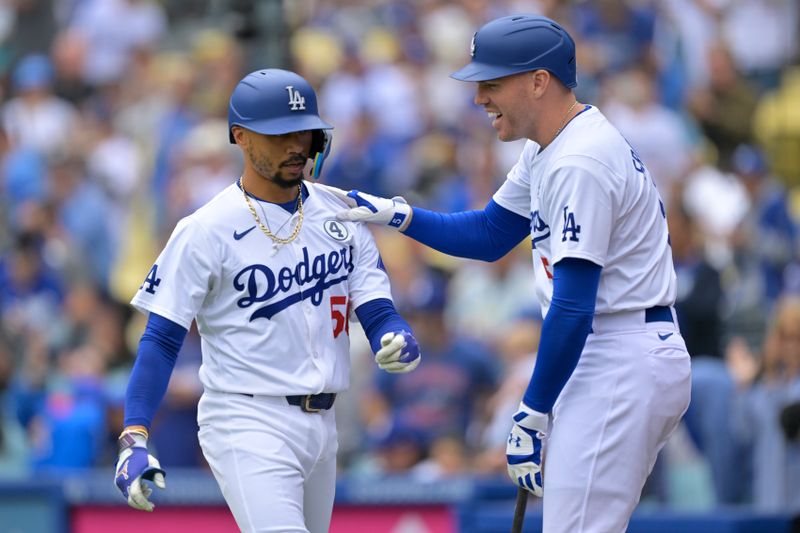 Jun 2, 2024; Los Angeles, California, USA;  Los Angeles Dodgers shortstop Mookie Betts (50) is greeted by first base Freddie Freeman (5) of the after hitting a solo home run in the first inning against the Colorado Rockies at Dodger Stadium. Mandatory Credit: Jayne Kamin-Oncea-USA TODAY Sports