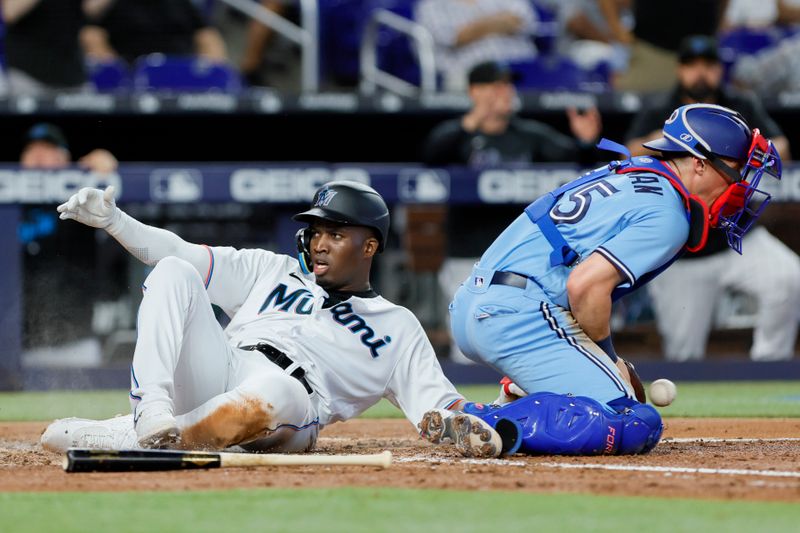 Jun 21, 2023; Miami, Florida, USA; Miami Marlins right fielder Jesus Sanchez (7) scores after a two-run double from first baseman Garrett Cooper (not pictured) against the Toronto Blue Jays during the fourth inning at loanDepot Park. Mandatory Credit: Sam Navarro-USA TODAY Sports