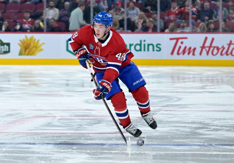 Oct 17, 2024; Montreal, Quebec, CAN; Montreal Canadiens defenseman Lane Hutson (48) plays the puck during the second period of the game against the Los Angeles Kings  at the Bell Centre. Mandatory Credit: Eric Bolte-Imagn Images