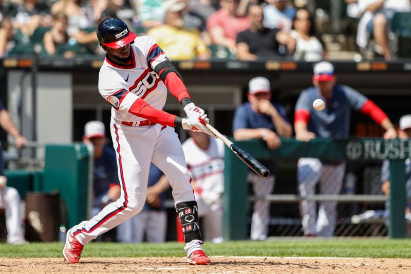 Jul 9, 2023; Chicago, Illinois, USA; Chicago White Sox center fielder Luis Robert Jr. (88) hits a sacrifice fly against the St. Louis Cardinals during the eighth inning at Guaranteed Rate Field. Mandatory Credit: Kamil Krzaczynski-USA TODAY Sports