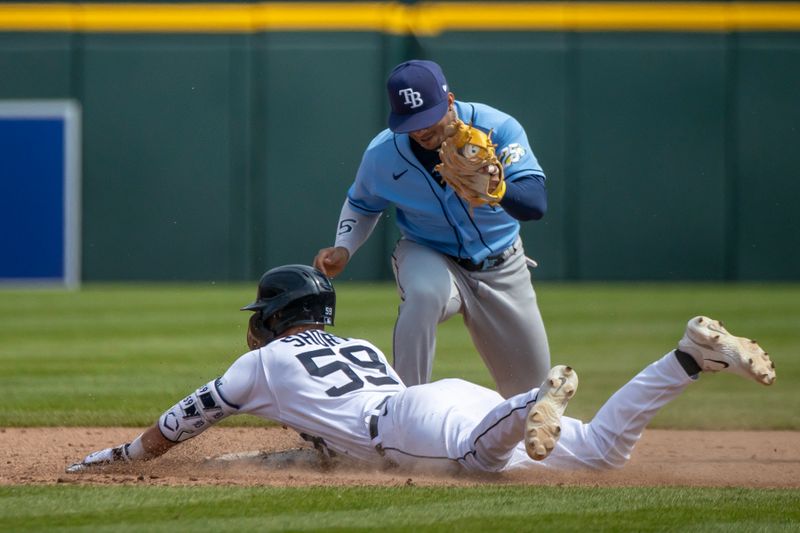 Aug 5, 2023; Detroit, Michigan, USA; Detroit Tigers second baseman Zack Short (59) slides head first into second base after hitting a double and beats the tag by Tampa Bay Rays shortstop Wander Franco (5) at Comerica Park. Mandatory Credit: David Reginek-USA TODAY Sports