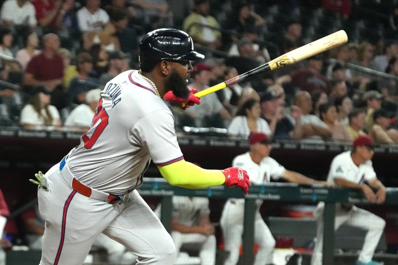 Jul 8, 2024; Phoenix, Arizona, USA; Atlanta Braves designated hitter Marcell Ozuna (20) hits an RBI sacrifice fly out against the Arizona Diamondbacks in the eleventh inning at Chase Field. Mandatory Credit: Rick Scuteri-USA TODAY Sports