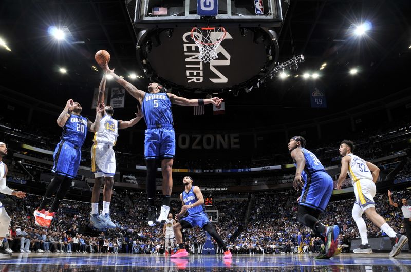 ORLANDO, FL - MARCH 27: Paolo Banchero #5 of the Orlando Magic handles the ball during the game against the Golden State Warriors on March 27, 2024 at Amway Center in Orlando, Florida. NOTE TO USER: User expressly acknowledges and agrees that, by downloading and or using this photograph, User is consenting to the terms and conditions of the Getty Images License Agreement. Mandatory Copyright Notice: Copyright 2024 NBAE (Photo by Fernando Medina/NBAE via Getty Images)