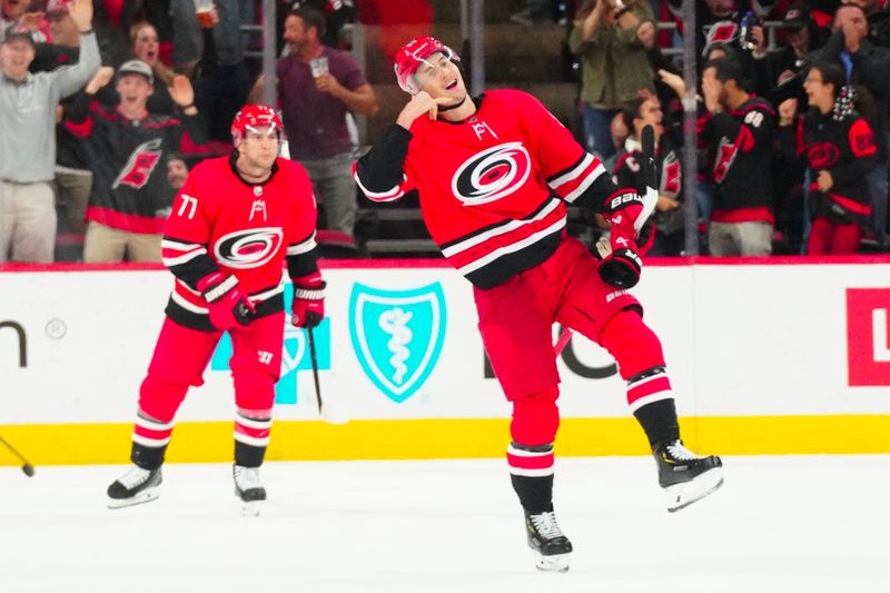 Oct 26, 2023; Raleigh, North Carolina, USA; Carolina Hurricanes center Martin Necas (88) celebrates his game winning goal in the overtime against the Seattle Kraken at PNC Arena. Mandatory Credit: James Guillory-USA TODAY Sports