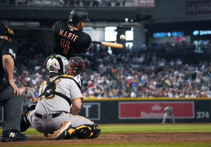 Jul 9, 2023; Phoenix, Arizona, USA;  Arizona Diamondbacks Ketel Marte (4) hits a double in the sixth inning against the Pittsburgh Pirates at Chase Field. Mandatory Credit: Joe Rondone-USA TODAY Sports