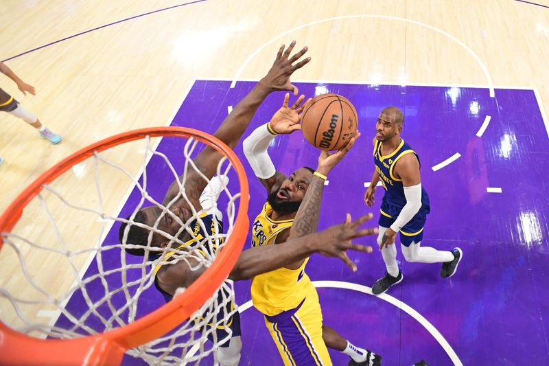 LOS ANGELES, CA - APRIL 9: LeBron James #23 of the Los Angeles Lakers drives to the basket during the game against the Golden State Warriors on April 9, 2024 at Crypto.Com Arena in Los Angeles, California. NOTE TO USER: User expressly acknowledges and agrees that, by downloading and/or using this Photograph, user is consenting to the terms and conditions of the Getty Images License Agreement. Mandatory Copyright Notice: Copyright 2024 NBAE (Photo by Adam Pantozzi/NBAE via Getty Images)